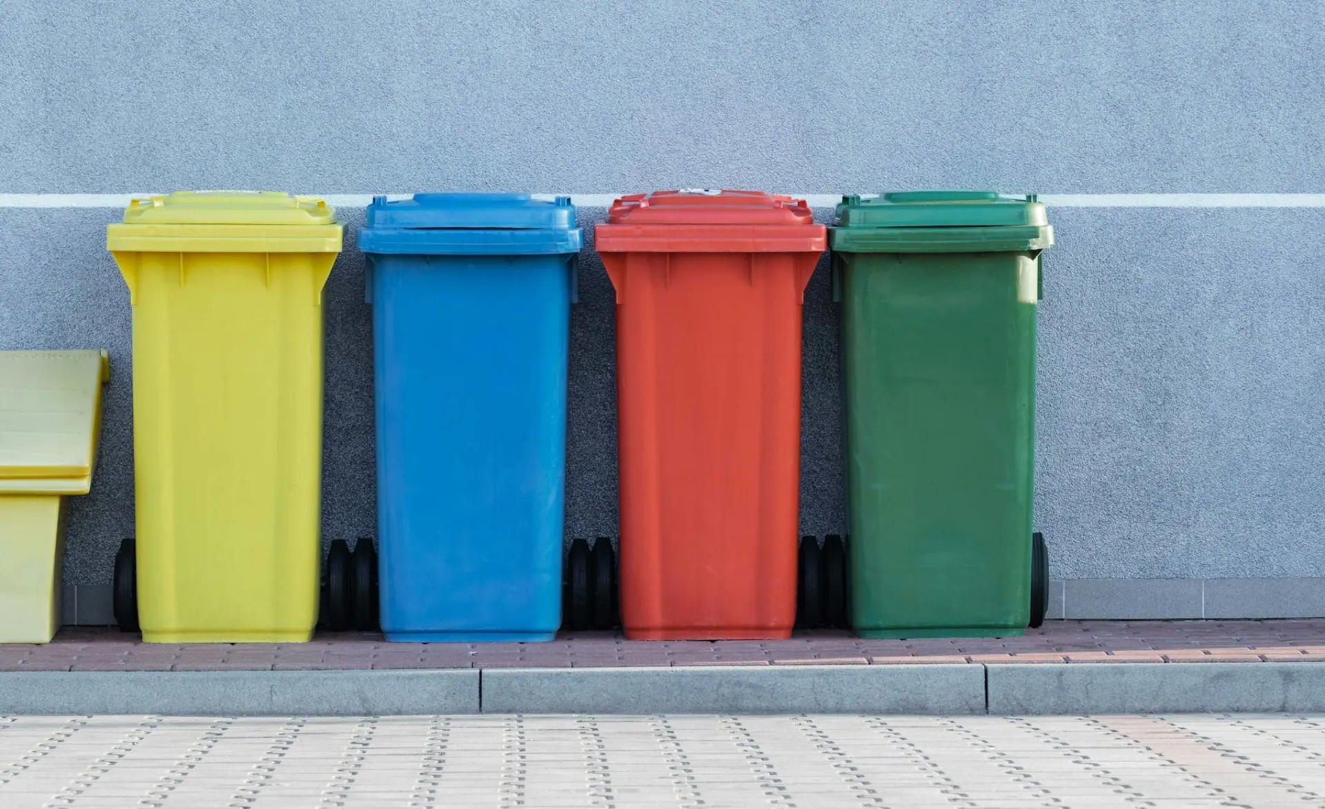 Commercial recycling and waste containers prepared for managed collection